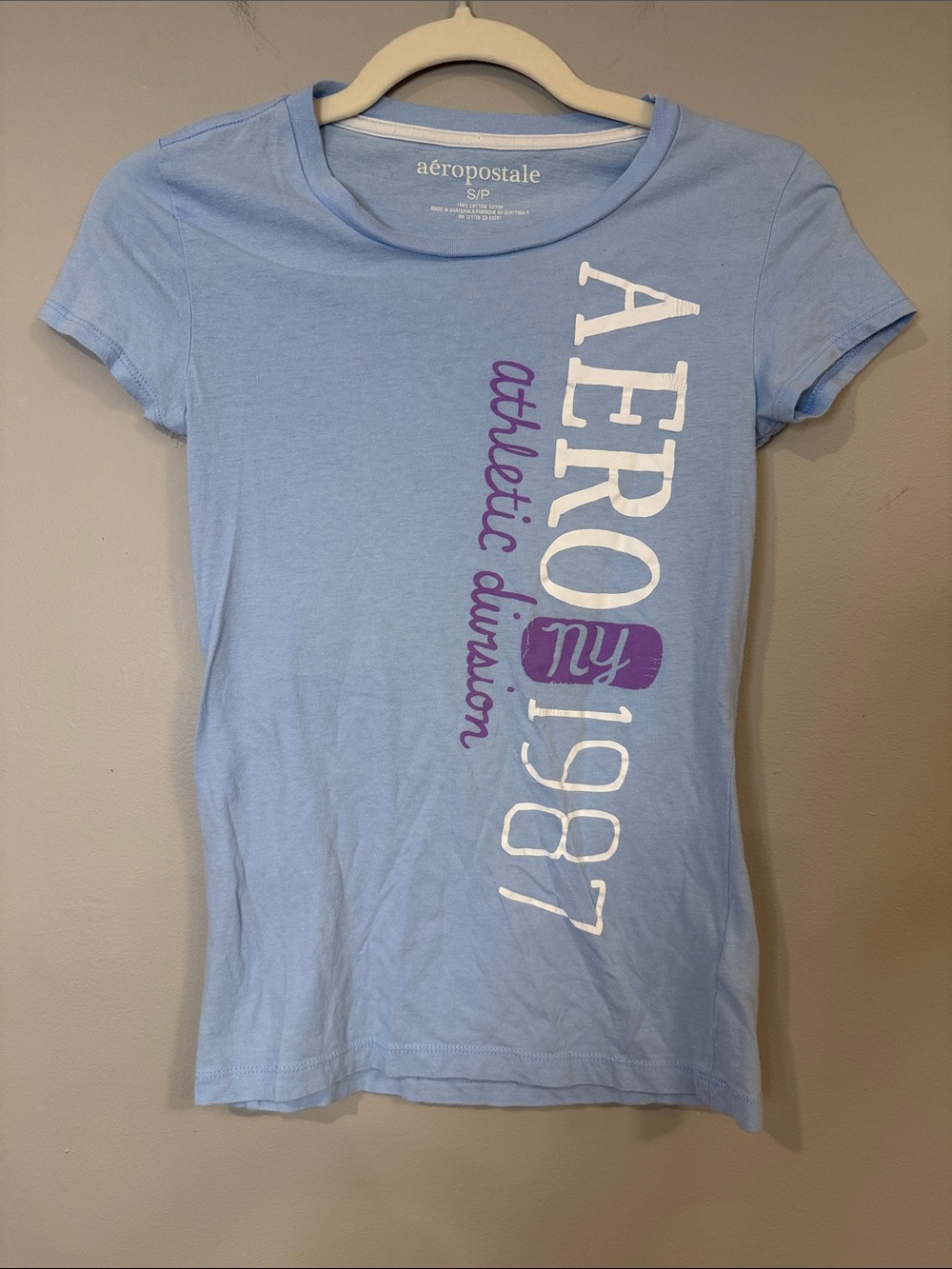 Aeropostale Light Blue Graphic Tee with Purple and white writing longer length